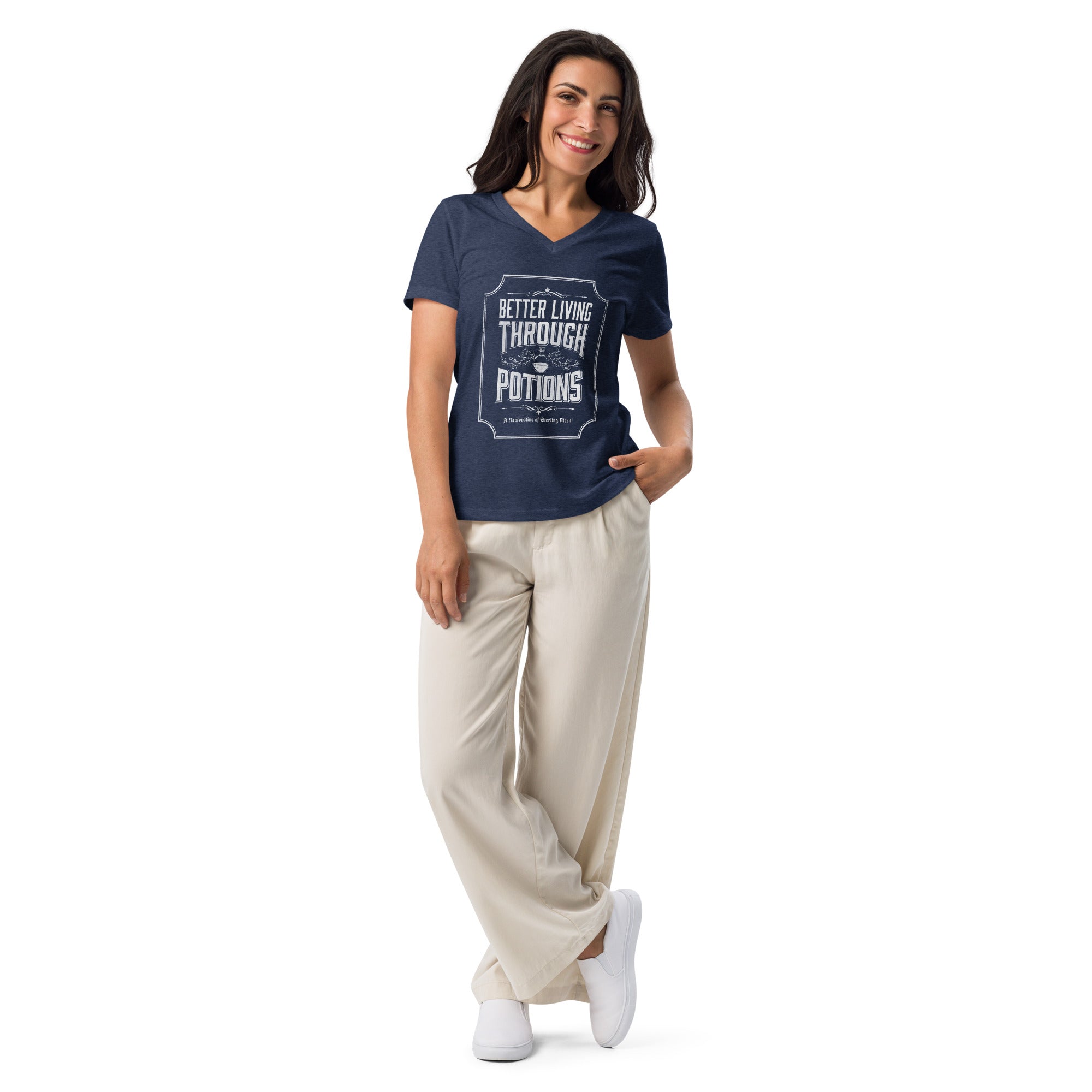 Woman wearing heather navy vneck t-shirt with better living through potions design on it and relaxed white pants