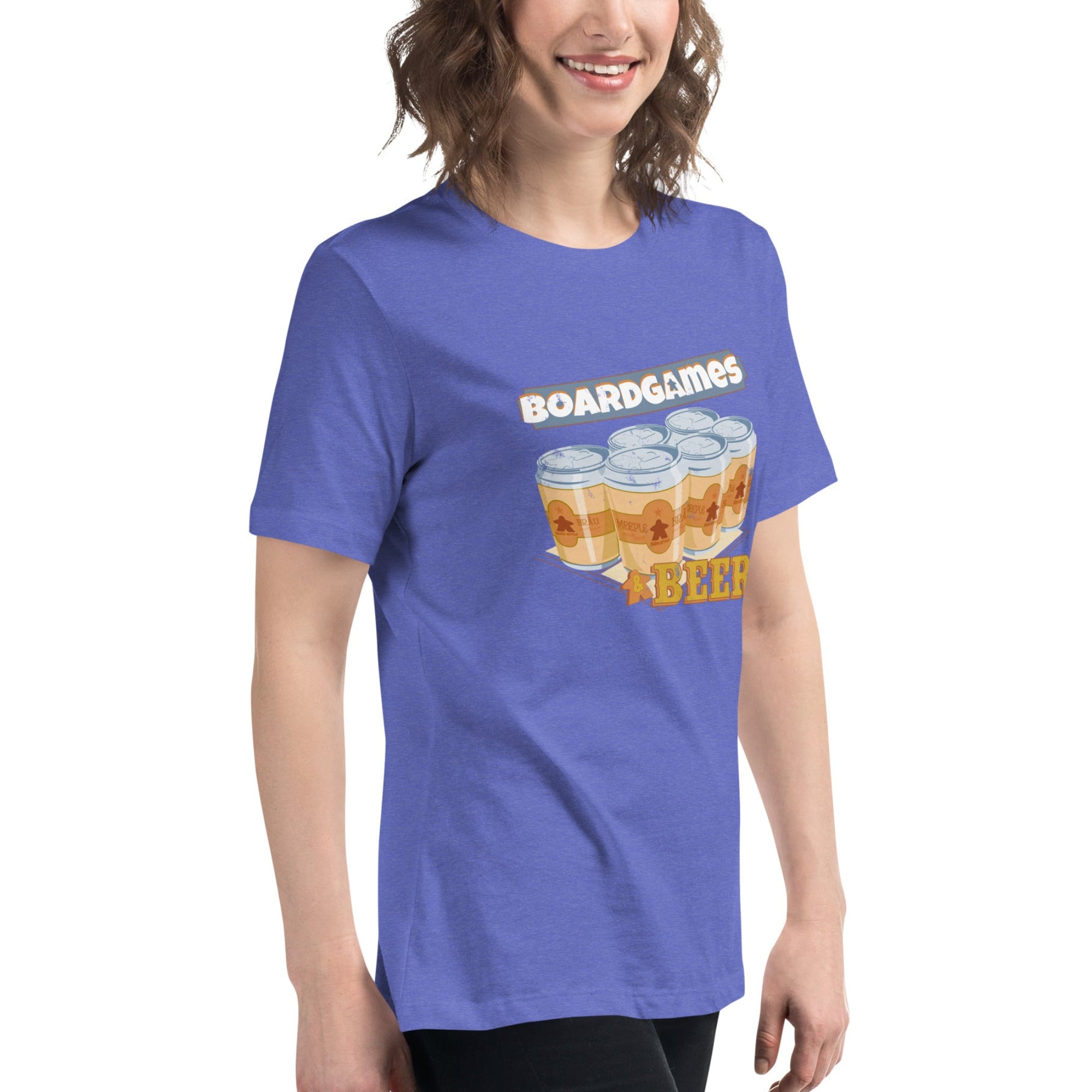A woman wearing a heathered periwinkle blue t-shirt with a graphic that reads 'BOARDGAMES BEER' above and below an illustration of six beer cans shown against a plain white background.