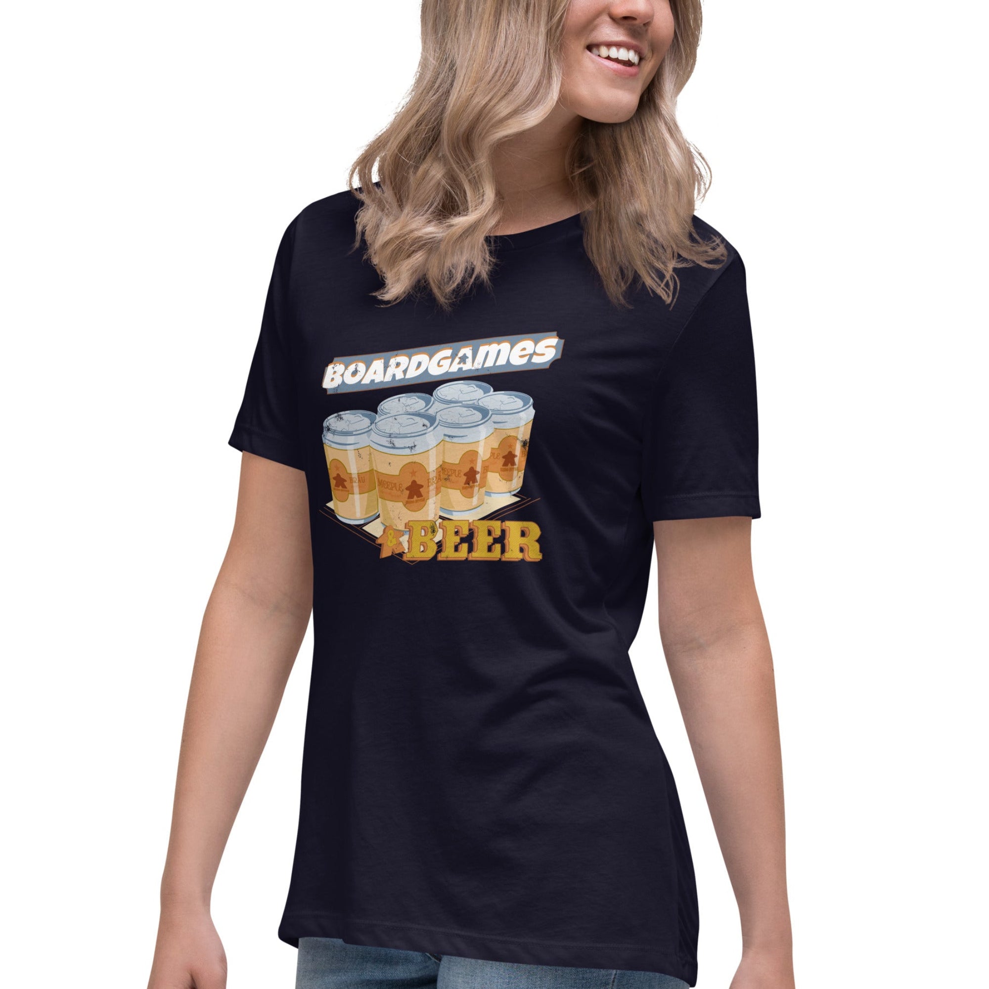 A woman wearing a navy blue graphic t-shirt with a 'Boardgames & Beer' design featuring illustrated beer cans, paired with blue jeans, against a plain white background.
