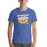 A man wearing a heather blue crewneck t-shirt with a graphic print that reads 'BOARDGAMES BEER' above an illustration of six beer cans.