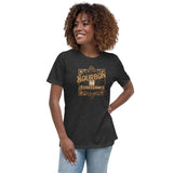 A woman wearing a heather grey t-shirt with a bourbon and board games design on the front.
