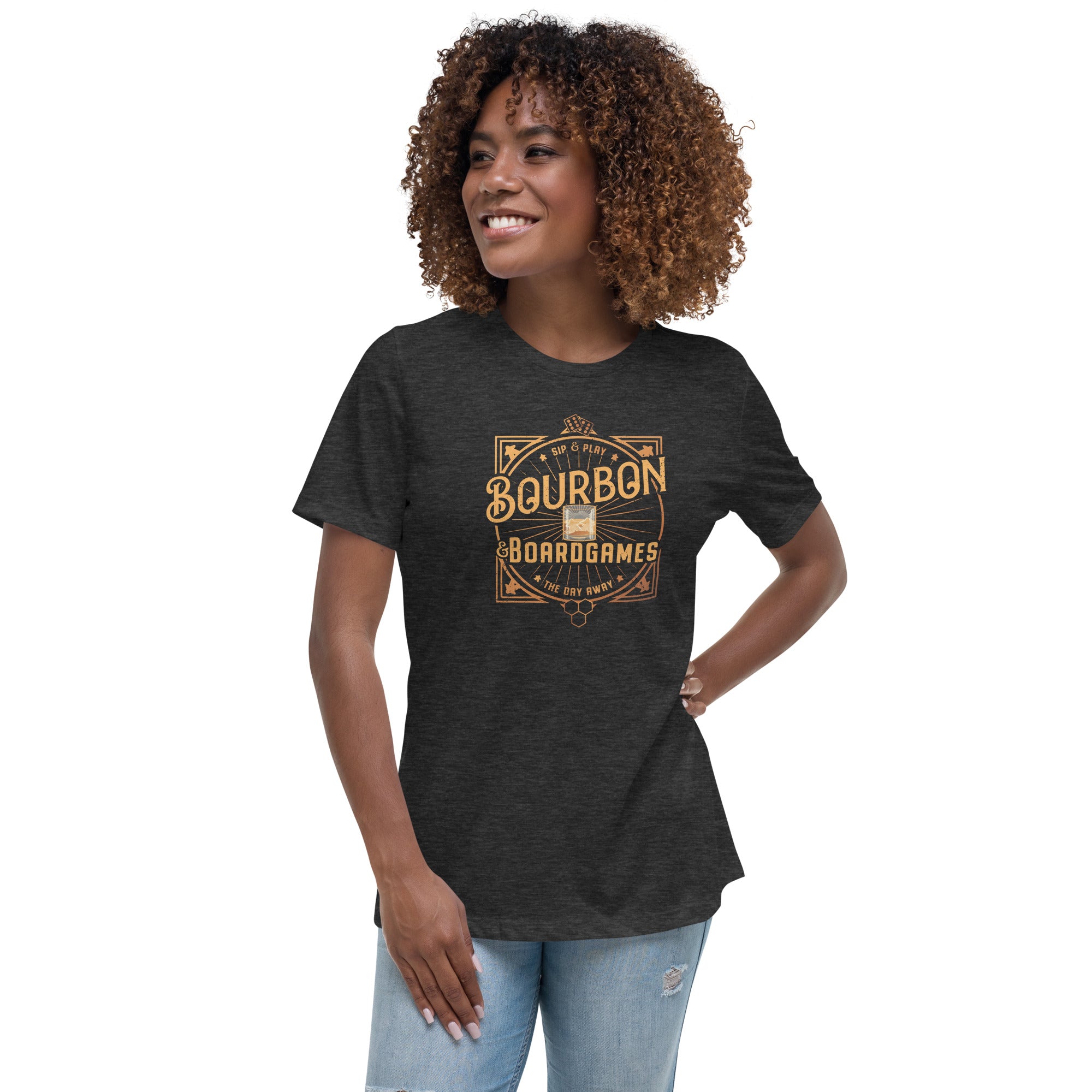 A woman wearing a heather grey t-shirt with a bourbon and board games design on the front.