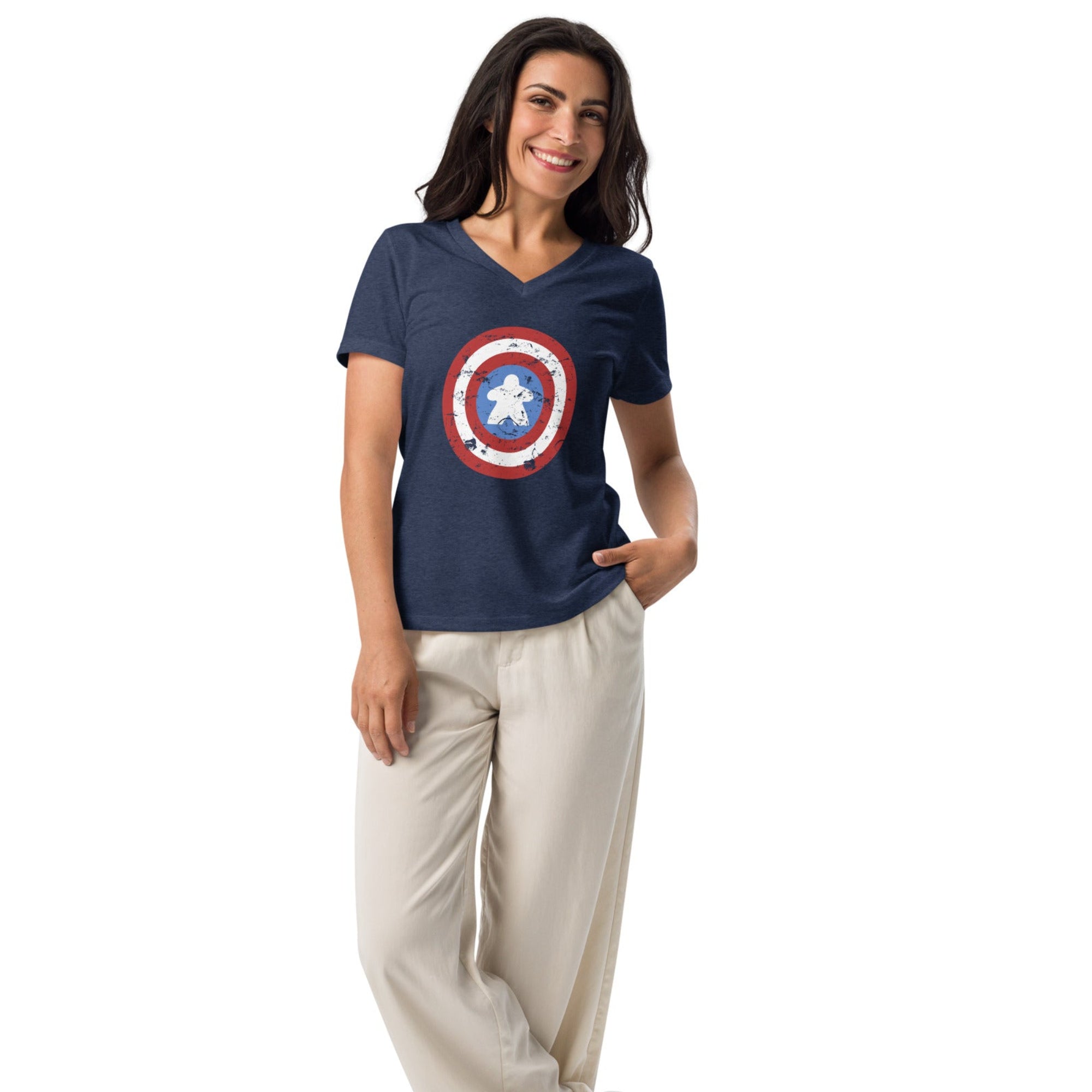 A women's V-neck t-shirt in 100% ringspun cotton printed with a red, white, and blue shield design featuring a wooden meeple at its center in place of a star.