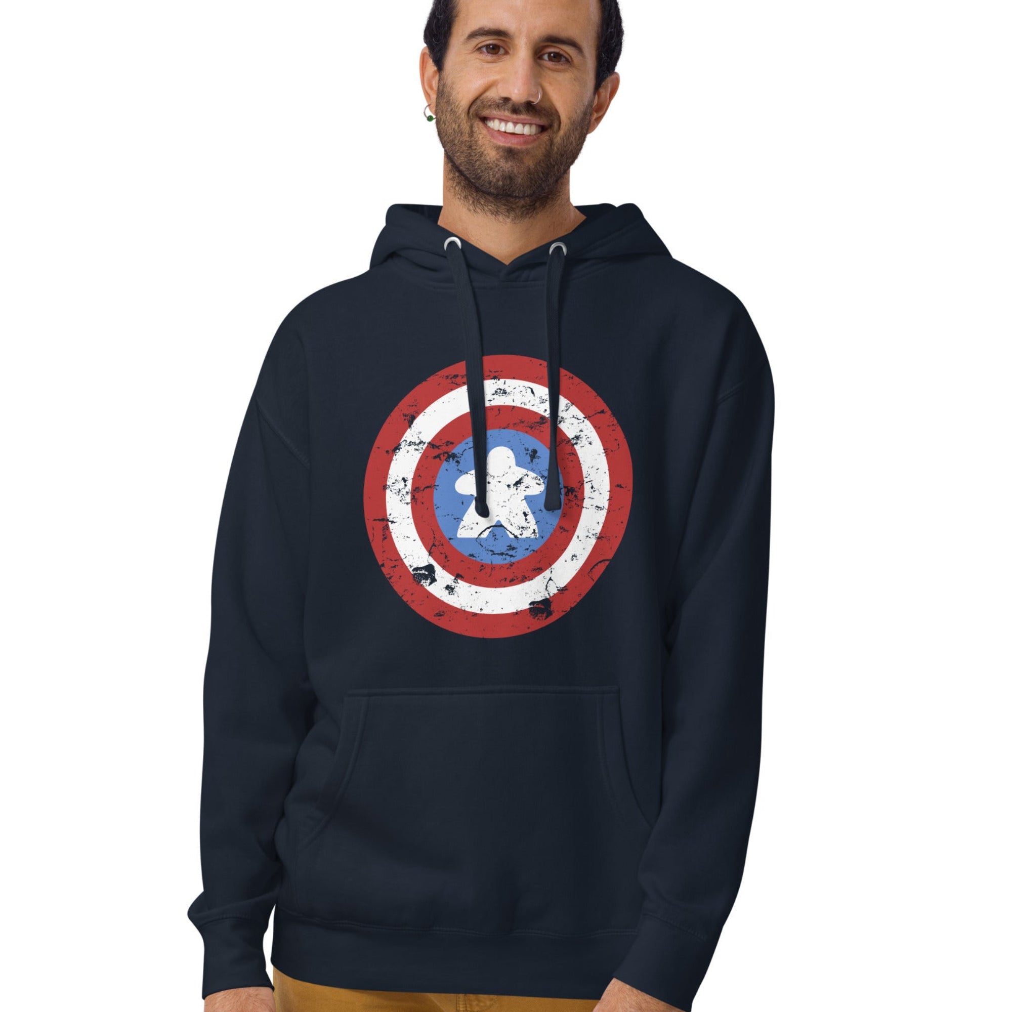 A pullover hoodie printed with a red, white, and blue shield design featuring a  meeple at its center in place of a star.