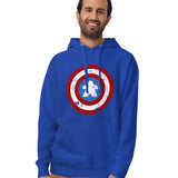 A man wearing a royal blue hoodie with a distressed Captain Meeple shield graphic on the chest, paired with tan pants, against a plain white background.