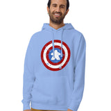 A man wearing a light blue pullover hoodie with a distressed Captain Meeple shield graphic on the chest, paired with brown pants, against a plain white background.