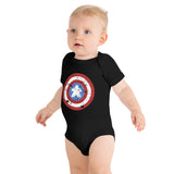 A baby wearing a black short-sleeve bodysuit with a distressed Captain Meeple shield graphic on the chest, photographed against a solid white background.