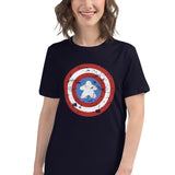 A women's fitted t-shirt in 100% ringspun cotton printed with a red, white, and blue shield design featuring a meeple at its center in place of a star.