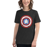 A woman wearing a dark heather gray t-shirt with a distressed Captain shield graphic on the chest with a meeple in the center, set against a plain white background.