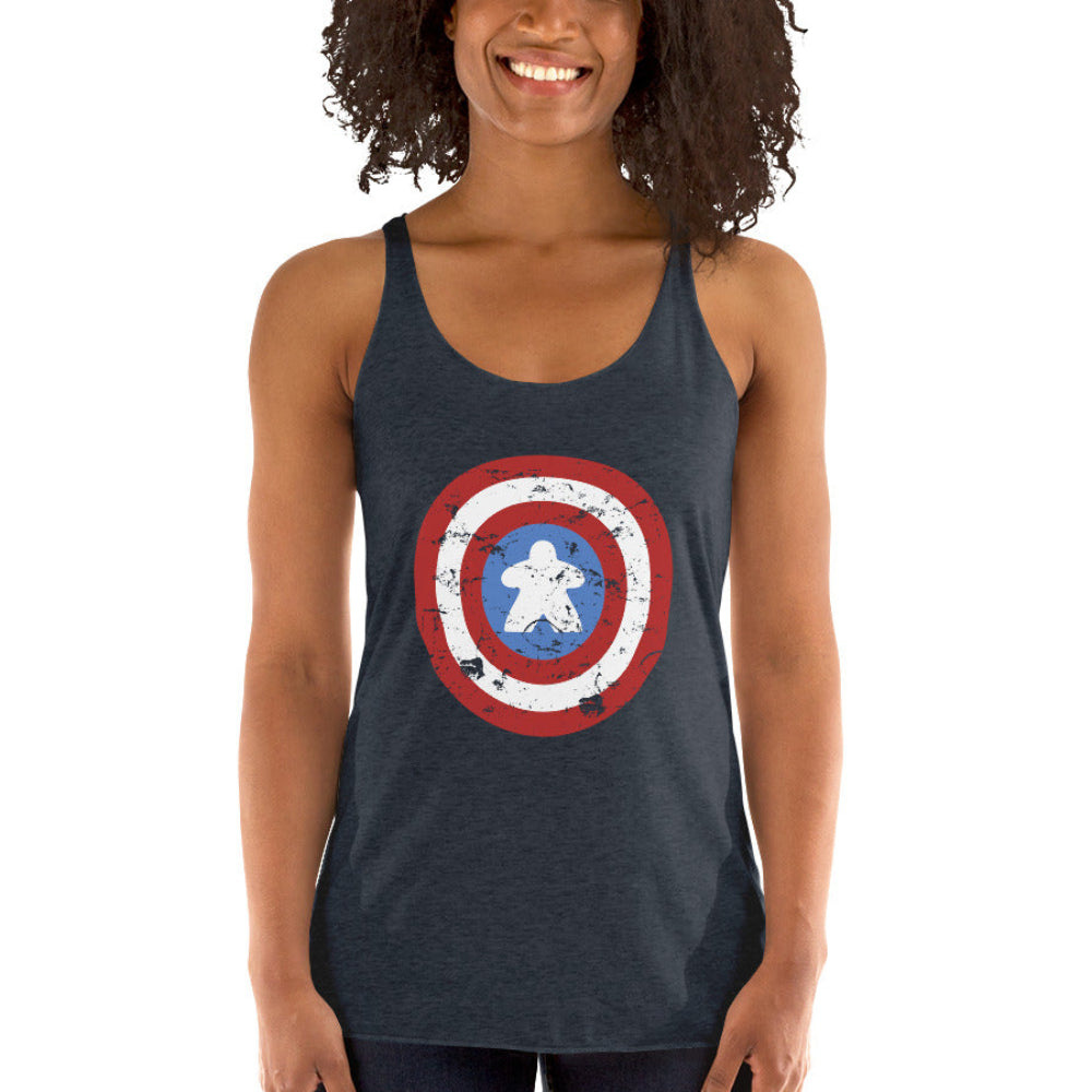 Woman wearing a vintage black racerback tank top with the Captain Meeple shield on the front featuring a meeple at the center instead of a star.