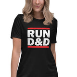 A woman wearing a black short-sleeve t-shirt with a bold graphic on the chest that reads 'RUN D&D' in white letters between two red horizontal bars. She is set against a plain white background.